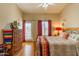 Bright bedroom with wood floors, a sliding glass door, and ample natural light at 7101 W Beardsley Rd # 422, Glendale, AZ 85308