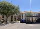 Exterior view of a two-story apartment building with balconies, parking, and mature trees at 7101 W Beardsley Rd # 422, Glendale, AZ 85308