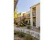 Exterior of a two-story apartment with private patios, gravel landscaping, and stairs at 7101 W Beardsley Rd # 422, Glendale, AZ 85308
