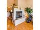 Cozy living room featuring a tiled fireplace, wood floors, and view into the kitchen at 7101 W Beardsley Rd # 422, Glendale, AZ 85308