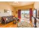 Comfortable living room with a balcony showcasing golf course views and ample natural light at 7101 W Beardsley Rd # 422, Glendale, AZ 85308