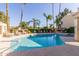Bright and inviting community pool with chairs, palm trees, and a clear blue sky at 7101 W Beardsley Rd # 422, Glendale, AZ 85308