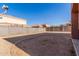 Expansive backyard with dirt and gravel landscaping, block fencing, and patio at 7227 S 13Th Way, Phoenix, AZ 85042
