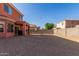 Gravel backyard with block wall fencing for privacy and covered patio, perfect for outdoor enjoyment and entertaining at 7227 S 13Th Way, Phoenix, AZ 85042