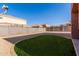 Wide backyard featuring a well maintained lawn, gravel landscaping, and a block fence for privacy at 7227 S 13Th Way, Phoenix, AZ 85042