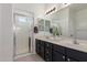 Bathroom featuring dual sinks, modern vanity, and a glass-enclosed walk-in shower at 7227 S 13Th Way, Phoenix, AZ 85042