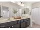 Bathroom featuring dual sinks, modern vanity, and a decorative mirror at 7227 S 13Th Way, Phoenix, AZ 85042
