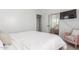 Well-lit bedroom boasting a blush chair, neutral carpet, and a sliding door closet at 7227 S 13Th Way, Phoenix, AZ 85042