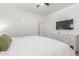 Neutral toned bedroom showcasing a modern TV, dresser, and cozy white linens at 7227 S 13Th Way, Phoenix, AZ 85042