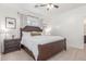 Bright bedroom featuring a dark wood bed frame, neutral carpet, and natural light at 7227 S 13Th Way, Phoenix, AZ 85042