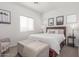 Bright bedroom with a plush upholstered ottoman, warm carpet, and natural light at 7227 S 13Th Way, Phoenix, AZ 85042