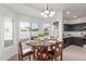 Bright dining area with a wooden table, chandelier, and an abundance of natural light at 7227 S 13Th Way, Phoenix, AZ 85042