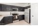 Bright kitchen featuring stainless steel appliances, quartz countertops, and tile floors at 7227 S 13Th Way, Phoenix, AZ 85042