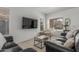 Cozy living room with modern decor, a flat-screen TV, and comfortable seating area at 7227 S 13Th Way, Phoenix, AZ 85042