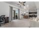 Open-concept living space features carpet floors, natural light, and access to the backyard at 7227 S 13Th Way, Phoenix, AZ 85042