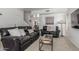 Comfortable living room with leather sofas, modern decor, and natural lighting at 7227 S 13Th Way, Phoenix, AZ 85042