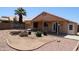 The backyard has a covered patio area, garden beds and low maintenance desert landscaping at 7425 N 69Th Ln, Glendale, AZ 85303