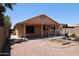 The backyard features gravel landscaping, a covered patio, and raised planting beds at 7425 N 69Th Ln, Glendale, AZ 85303