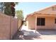 Fenced backyard showing home exterior, covered patio, and low maintenance gravel landscaping at 7425 N 69Th Ln, Glendale, AZ 85303