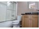 This bathroom features a shower over bath and a vanity with a decorative mirror at 7425 N 69Th Ln, Glendale, AZ 85303