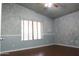 Spacious bedroom with wood floors and a large window at 7425 N 69Th Ln, Glendale, AZ 85303