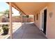 Covered patio with concrete floor, lush garden plot, and backyard view, offering outdoor relaxation at 7425 N 69Th Ln, Glendale, AZ 85303