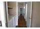 Hallway with wood flooring, beige walls, and white doors leading to various rooms of the house at 7425 N 69Th Ln, Glendale, AZ 85303