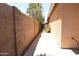 View of a side yard featuring a block wall, foliage, and the home's exterior at 7425 N 69Th Ln, Glendale, AZ 85303