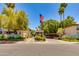Community entrance featuring flags, landscaping, and a sign at 7557 N Dreamy Draw Dr # 139, Phoenix, AZ 85020
