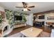 Inviting living room featuring a charming fireplace, hardwood floors, and open layout to the modern kitchen at 7557 N Dreamy Draw Dr # 139, Phoenix, AZ 85020
