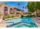 Community pool features a hot tub with nearby landscaped greenery and buildings at 7557 N Dreamy Draw Dr # 139, Phoenix, AZ 85020
