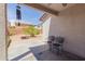 Inviting covered patio with two black chairs, leading to a spacious backyard at 9124 W Williams St, Tolleson, AZ 85353