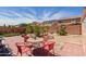 Backyard features a tiled patio, table set, and green landscaping, perfect for outdoor entertaining at 9124 W Williams St, Tolleson, AZ 85353