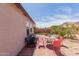 Backyard showcasing a patio with chairs and lush landscaping, providing a private outdoor retreat at 9124 W Williams St, Tolleson, AZ 85353