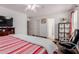 Comfortable bedroom featuring a large bed, ceiling fan, and access to the en-suite bathroom at 9124 W Williams St, Tolleson, AZ 85353