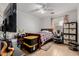 Functional bedroom featuring a bed, desk area, storage cubes, and comfortable gaming chair at 9124 W Williams St, Tolleson, AZ 85353