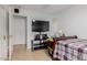 Cozy bedroom featuring a TV, neutral walls, and tiled flooring, offering a comfortable and private space at 9124 W Williams St, Tolleson, AZ 85353