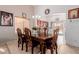 Traditional dining room featuring dark wood table and chairs, and direct access to the kitchen at 9124 W Williams St, Tolleson, AZ 85353