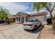Single-story home with a two-car garage, stone landscaping, and inviting curb appeal at 9124 W Williams St, Tolleson, AZ 85353