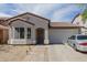 Inviting single-story home features a neutral color palette and a convenient two-car garage at 9124 W Williams St, Tolleson, AZ 85353