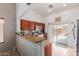Well-lit kitchen with granite countertops, stainless steel appliances and sliding doors to the backyard at 9124 W Williams St, Tolleson, AZ 85353