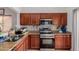 Efficient kitchen layout with stainless steel appliances, granite countertops and ample cabinet space at 9124 W Williams St, Tolleson, AZ 85353