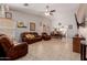 Open-concept living room offering tile floors, abundant natural light, and comfortable seating at 9124 W Williams St, Tolleson, AZ 85353