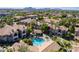 Aerial view showcasing a community pool, palm trees, and residential buildings with red tile roofs at 9600 N 96Th St # 171, Scottsdale, AZ 85258