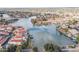 Stunning aerial view of a waterfront community with lush landscaping, and beautiful homes nestled along a serene lake at 10429 N 101St St, Scottsdale, AZ 85258