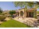 An inviting backyard with a patio, seating area, manicured plants and lush lawn at 10429 N 101St St, Scottsdale, AZ 85258