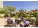 Relaxing patio area with built-in fire pit and lush landscaping at 10429 N 101St St, Scottsdale, AZ 85258