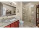 Bathroom showcasing single vanity sink, toilet and glass enclosed tiled shower at 10429 N 101St St, Scottsdale, AZ 85258
