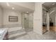 This bathroom features a bathtub, glass enclosed shower and stylish tile floors at 10429 N 101St St, Scottsdale, AZ 85258
