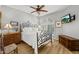 Cozy bedroom featuring decorative wrought iron headboard and ceiling fan and hard wood floors at 10429 N 101St St, Scottsdale, AZ 85258